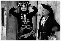 Two generations of tribewomen outside their house, near Mai Chau. Northwest Vietnam (black and white)