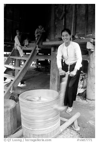 Woman of the Thai ethnicity milling grain, near Mai Chau. Northwest Vietnam (black and white)