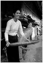 Woman of the Thai ethnicity sorting grain, near Mai Chau. Vietnam (black and white)