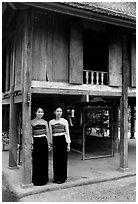Two thai women standing in front of their stilt house, Ban Lac village. Northwest Vietnam (black and white)