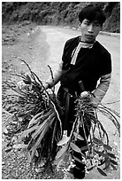 Man of Hmong ethnicity selling wild orchids, near Moc Chau. Vietnam (black and white)