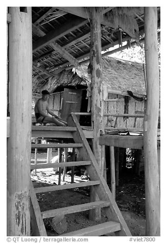 Elderly Montagnard man wearing the French beret on his porch, near Son La. Northwest Vietnam