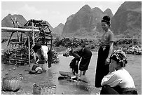 Thai women washing laundry and collecting water plants near an irrigation wheel, near Son La. Northwest Vietnam ( black and white)