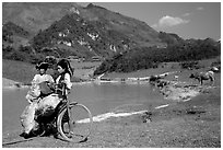 Thai women load a bicycle, near Tuan Giao. Northwest Vietnam (black and white)