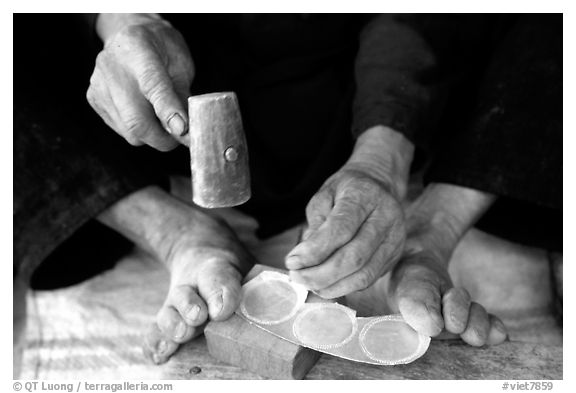 Hands and feet of a Black Dzao man making decorative coins, between Tam Duong and Sapa. Northwest Vietnam