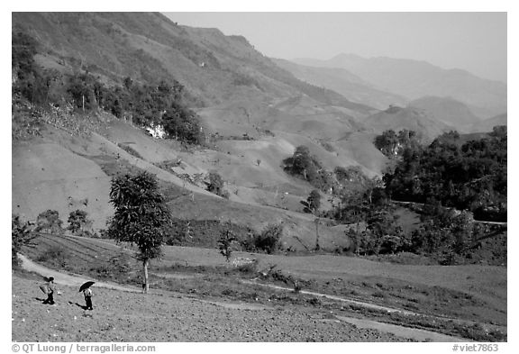 Two montagnards walking down a field, between Tuan Giao and Lai Chau. Northwest Vietnam