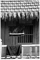 Detail of hut with montagnard dress being dried, between Tuan Giao and Lai Chau. Northwest Vietnam (black and white)