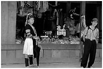 Man and montagnard woman in front of a store, near Lai Chau. Northwest Vietnam (black and white)