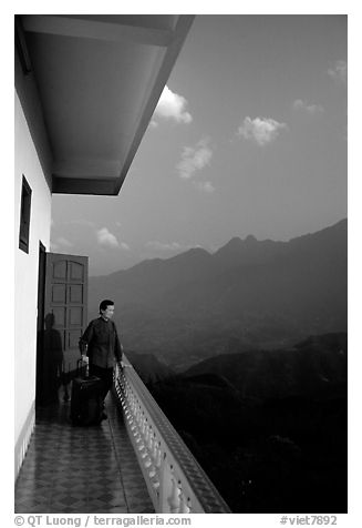 Traveler on a hotel balcony, looking at the Hoang Lien Mountains. Sapa, Vietnam (black and white)