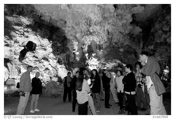 Tourists in illuminated cave. Halong Bay, Vietnam (black and white)