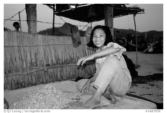 Girl drying shrimp. Ha Tien, Vietnam (black and white)