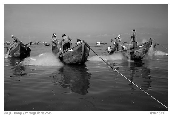 Fishermen get their nets out of their small fishing boats. Vung Tau, Vietnam