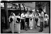 Uniformed school girls exit school. Ho Chi Minh City, Vietnam (black and white)