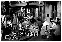 Eating in a street restaurant. Ho Chi Minh City, Vietnam (black and white)