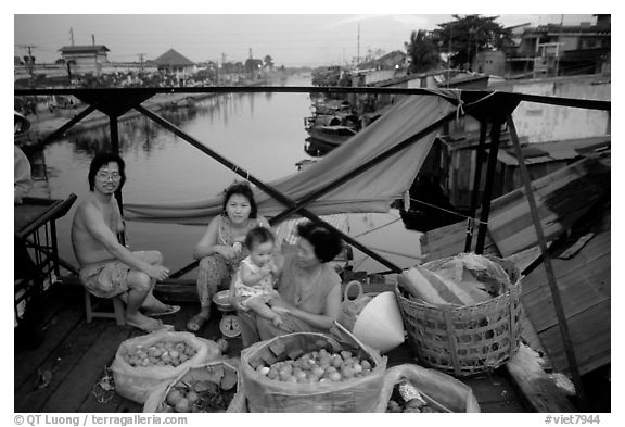 Family selling fruit on a bridge. Cholon, Ho Chi Minh City, Vietnam (black and white)