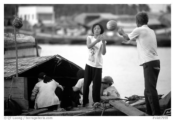 Unloading watermelons from a boat. Ha Tien, Vietnam (black and white)