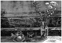 Flowers, fruit, and incense offered on a grave. Ben Tre, Vietnam (black and white)