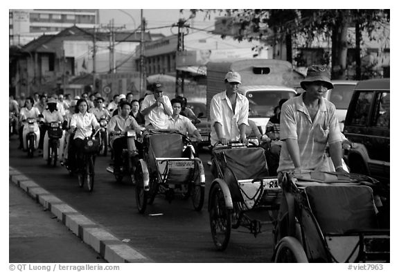 Cyclos and morning traffic. Ho Chi Minh City, Vietnam (black and white)