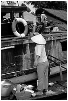 Passsing a bowl of pho from boat to boat. Can Tho, Vietnam ( black and white)