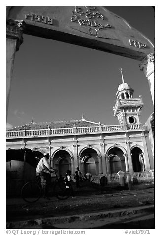 Bicylist in front of a mosque. Chau Doc, Vietnam (black and white)