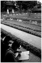 Art students drawing in the Temple of the Litterature. Hanoi, Vietnam (black and white)