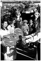 Gifts are exchanged as a newly wedded couple exits the bride's home. Ho Chi Minh City, Vietnam (black and white)