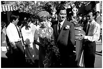 Newly-wed couple exit the bride's home. Ho Chi Minh City, Vietnam ( black and white)