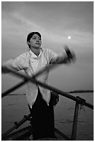 Woman using X-shaped paddles on the Mekong river, Can Tho. Vietnam (black and white)