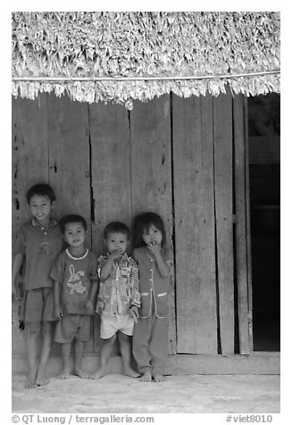 Children in front of rural hut, Hon Chong. Vietnam (black and white)