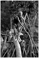 Elderly man not afraid of crossing a bamboo bridge, near Long Xuyen. Vietnam (black and white)