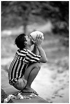 Drinking fresh coconut juice, cheaper than bottled water. Hong Chong Peninsula, Vietnam ( black and white)