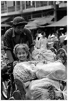 Elderly woman back from the market with plenty of groceries makes good use of cyclo. Cholon, Ho Chi Minh City, Vietnam (black and white)