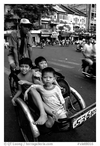Kids sharing cyclo ride, Ho Chi Minh city. Vietnam