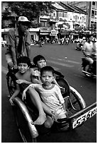 Kids sharing cyclo ride, Ho Chi Minh city. Vietnam (black and white)