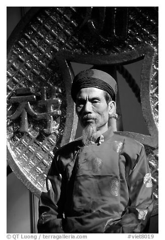 Elderly man in Ao Dai costume, a vanishing tradition. Ho Chi Minh City, Vietnam (black and white)