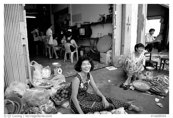 Old and new: street vendors and kids playing in a video games store. Ho Chi Minh City, Vietnam (black and white)