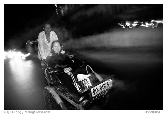 Enjoying the freshness of the night during a cyclo ride. Ho Chi Minh City, Vietnam