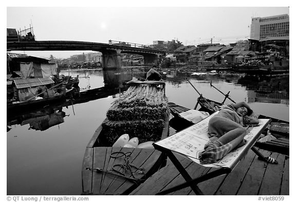 Sleeping out for the fresh air. Morning near the Saigon arroyo. Cholon, Ho Chi Minh City, Vietnam