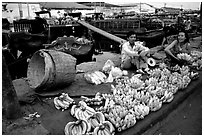 Selling freshly unloaded bananas near the Saigon arroyo. Cholon, Ho Chi Minh City, Vietnam (black and white)