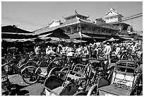 Cyclos wait outside the Bin Tay market in Cholon, district 6. Cholon, Ho Chi Minh City, Vietnam ( black and white)