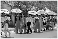 Traditional wedding procession on a countryside road. Ben Tre, Vietnam (black and white)