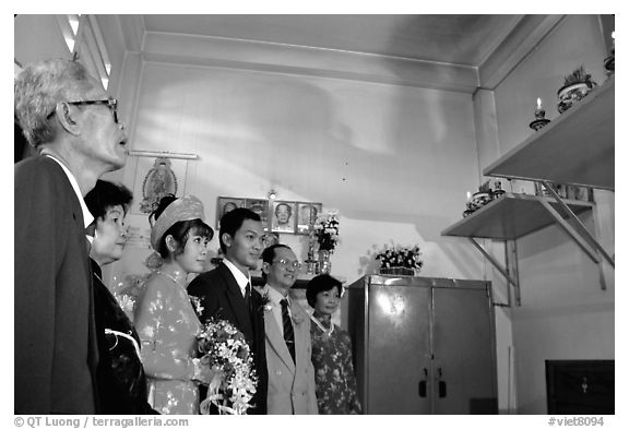 Bride presented to the groom's ancestors in the presence of both parents during a wedding. Ho Chi Minh City, Vietnam (black and white)
