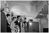 Bride presented to the groom's ancestors in the presence of both parents during a wedding. Ho Chi Minh City, Vietnam (black and white)