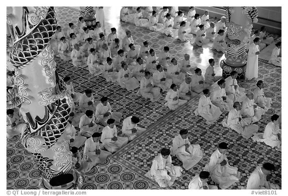 The noon ceremony, attended by priests inside the great Cao Dai temple. Tay Ninh, Vietnam