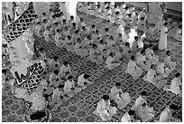 The noon ceremony, attended by priests inside the great Cao Dai temple. Tay Ninh, Vietnam (black and white)