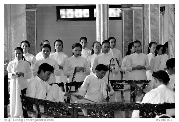 Traditional musicians during the noon ceremony. Tay Ninh, Vietnam