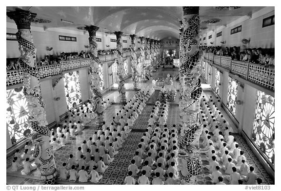 The noon ceremony, attended by priests inside the great Cao Dai temple. Tay Ninh, Vietnam