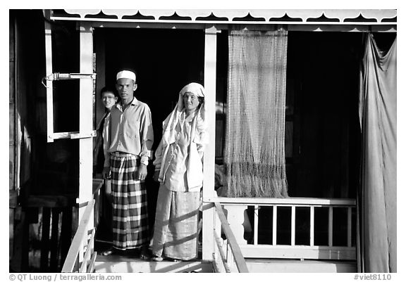 Muslem family outside stilt house in Cham minority village. Chau Doc, Vietnam