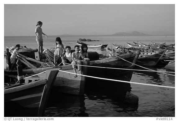 Children play on fishing boats. Vung Tau, Vietnam (black and white)