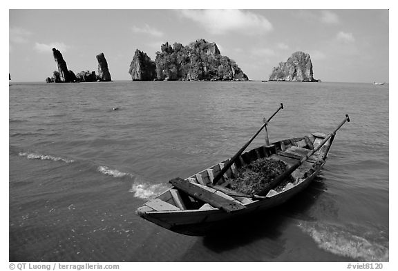 Boat and limestone towers, undeveloped beach. Hong Chong Peninsula, Vietnam